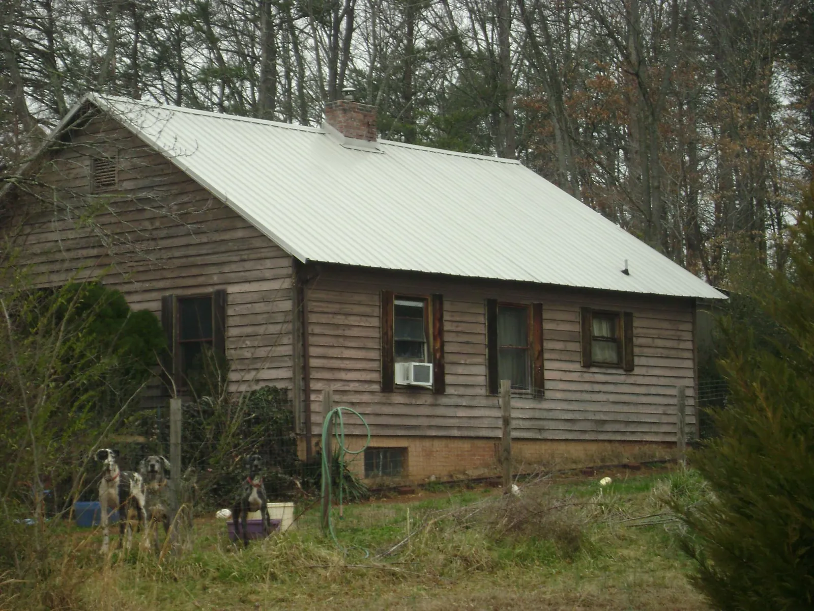 White metal roof on an old wood sided farmhouse, from a Metal Roof Installation job in Desmet